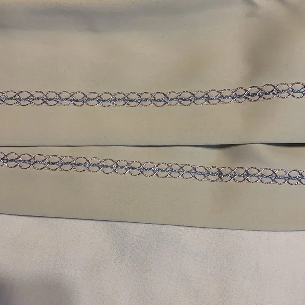 One pair (two panels) cream valance with blue/purple detail